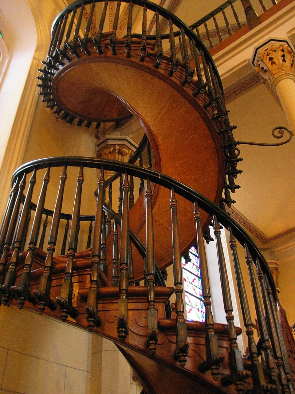 An ornate wooden spiral staircase.