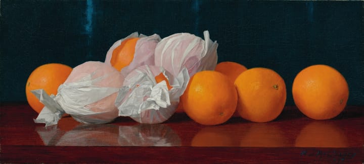 Several oranges, some in plastic wrap, on a table-top.
